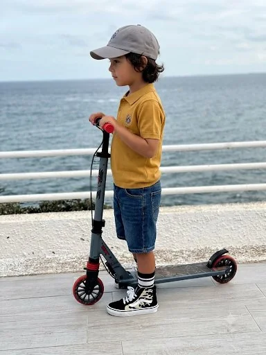 Boy on a scooter wearing the Harbor Gray Kids' Classic Lobster Cap